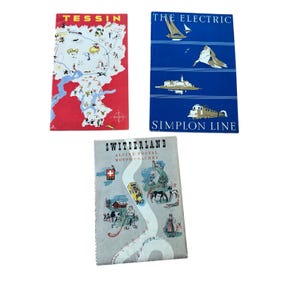 May include: Three vintage travel brochures featuring illustrations of Switzerland. One red brochure titled TESSIN shows a map, a blue one titled THE ELECTRIC SIMPLON LINE depicts a train and boat, and a gray one titled SWITZERLAND ALPINE POSTAL MOTOR COACHES.
