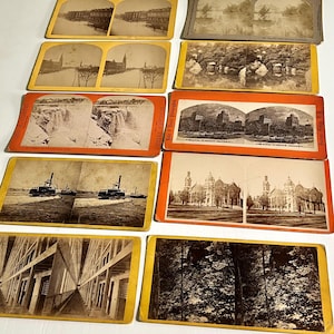 May include: A collection of vintage stereoscopic cards featuring sepia-toned images of landscapes, architecture, and transportation. The cards showcase scenes of Niagara Falls, steamboats, and buildings, with some cards labeled "Niagara Falls" and "Grand Union Hotel."