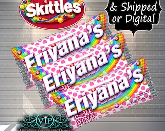 May include: Three pink and white Skittles candy wrappers with a rainbow design and the name "Eriyana's" printed on each. The wrappers are stacked on top of each other. The text "Sweet Sixteen" is printed on the wrappers. The bottom wrapper has the text "Love Pink" printed on it.