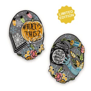 May include: Two gray embroidered patches with floral and seasonal designs. One features a pumpkin with the text "WHAT'S THIS?" and the other depicts a jar with the text "DEADLY NIGHT SHADE". A yellow "LIMITED EDITION" sticker is also present.
