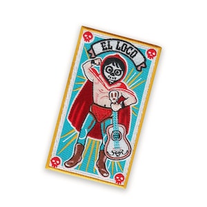 May include: Embroidered patch featuring a luchador-style skeleton character holding a guitar. The character wears a red cape, briefs, and boots, with the text "EL LOCO" on a banner. The patch has a gold border and skull accents.
