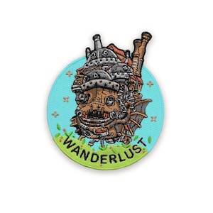 May include: Embroidered patch depicting a detailed illustration of a fantastical, steampunk-inspired moving castle. The patch is circular, with a light blue background and a green border. The word "WANDERLUST" is arched across the bottom.