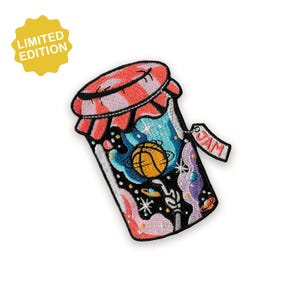 May include: Embroidered patch with a jar design, a basketball inside, and a red and white checked lid. The tag says "JAM". The patch has a yellow starburst with "LIMITED EDITION" text.