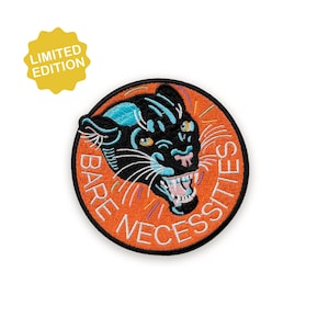 May include: Embroidered patch with a black panther head and blue highlights on an orange background. The patch reads "BARE NECESSITIES" and has a yellow "LIMITED EDITION" tag.