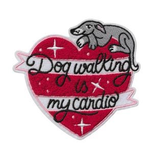 May include: Embroidered patch featuring a red heart with white stripes and the text "Dog walking is my cardio." A gray dog is perched at the top. The patch has a white border and pink accents.