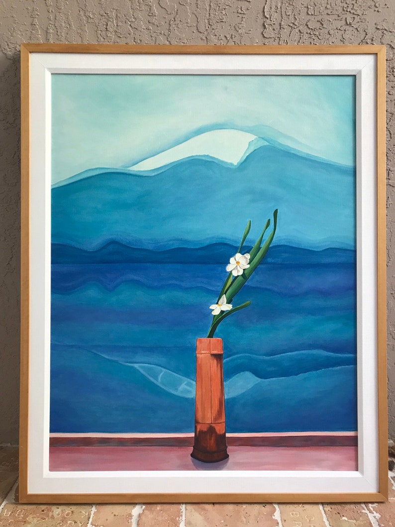 May include: A framed painting of a white flower in a brown vase against a blue and white mountain landscape.