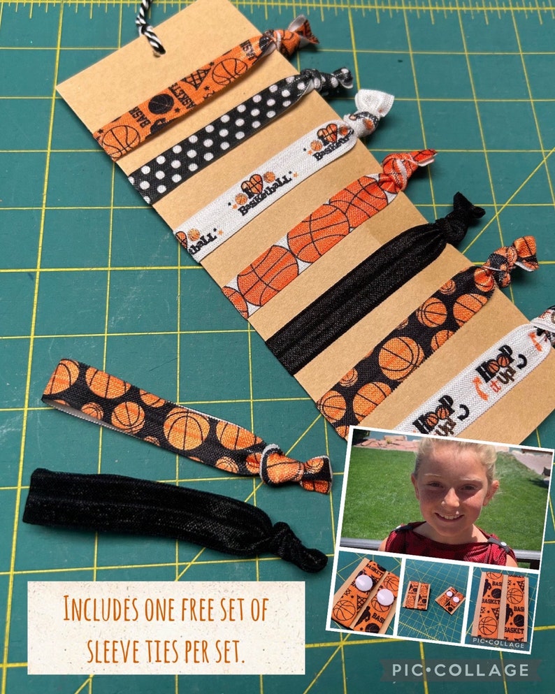 May include: A set of basketball-themed hair ties in various patterns, including basketballs, polka dots, and text. The ties are attached to a brown card with a black and white string. The image also includes a small photo collage.
