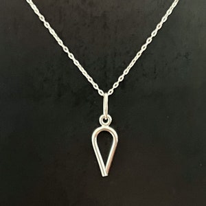 May include: A silver necklace with a teardrop-shaped pendant.