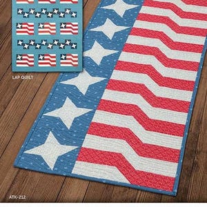 May include: A patriotic lap quilt and runner featuring a design inspired by the American flag. The quilt has a blue field with white stars and red and white stripes. The text "STAR SPANGLED" and "LAP QUILT" are visible.