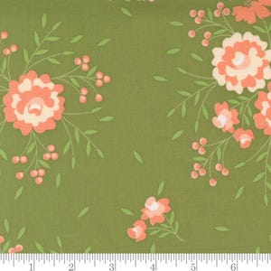 May include: A green fabric with a repeating pattern of pink flowers and green leaves. The flowers have a white center.
