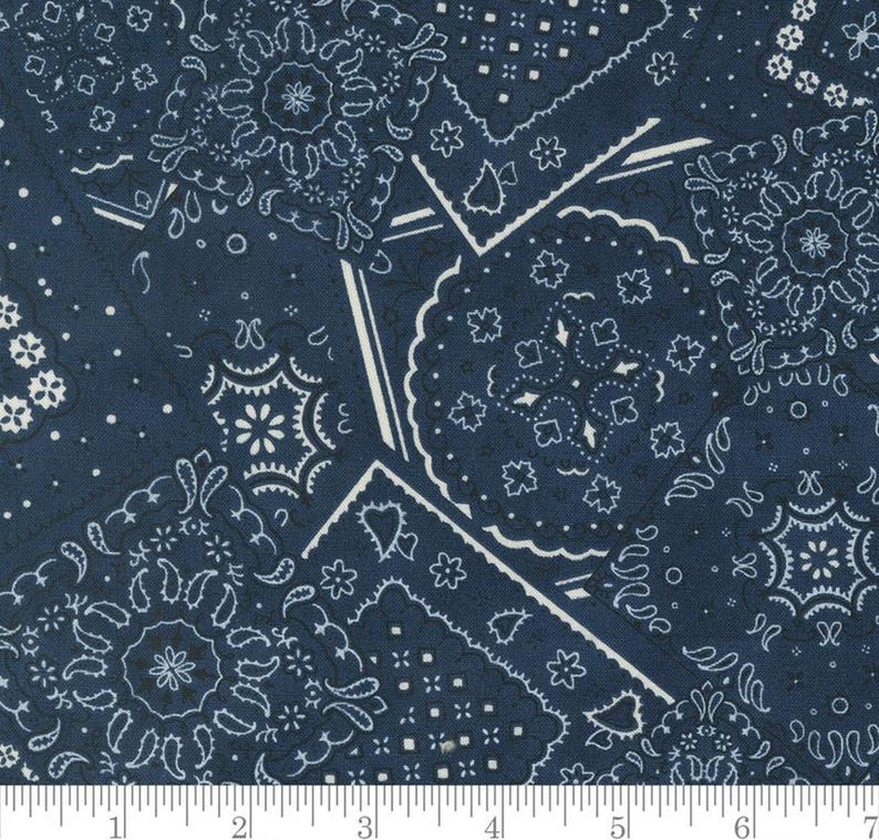 May include: Blue and white bandana print fabric with a patchwork design. The fabric features a variety of different bandana patterns, including paisley, stars, and diamonds.