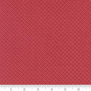 May include: A close-up of a red fabric with a repeating pattern of small, light red circles. The circles are evenly spaced across the fabric, creating a textured appearance. The fabric is likely cotton or a similar material.