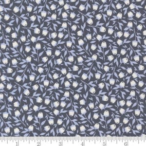 May include: Dark navy fabric with a repeating floral pattern. White bell-shaped flowers and light blue leaves and stems are scattered across the surface. The fabric is measured in inches.