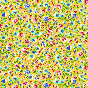 May include: A yellow fabric with a repeating pattern of small blue, pink, and white flowers. The flowers are scattered randomly across the fabric.
