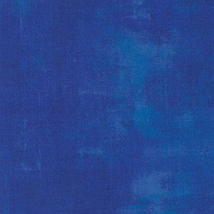 May include: A solid blue textured background with a slightly lighter blue hue in the center.