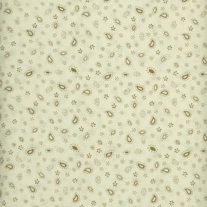 May include: A white fabric with a repeating pattern of small brown paisley shapes and tiny brown dots.
