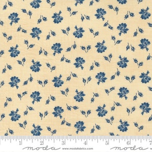 May include: A cream-colored fabric with a repeating pattern of small blue flowers and leaves. The fabric is marked with a ruler in inches and the word "moda" appears twice.