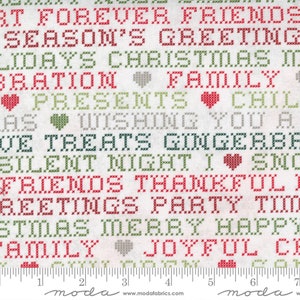 May include: White fabric with a red and green cross-stitch pattern featuring holiday greetings like "Forever Friends", "Season's Greetings", "Christmas", "Family", "Presents", "Wishing You A", "Gingerbread", "Silent Night", "Thankful", "Merry", "Happy", "Joyful", and "Celebrate".
