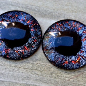 Puede incluir: Dos ojos redondos de pl&aacute;stico negro con detalles de purpurina roja y plateada. Los ojos tienen un di&aacute;metro de aproximadamente 2,5 cm.