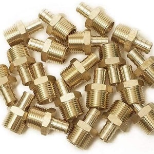 May include: A pile of brass plumbing fittings, also known as compression couplings, with a threaded end and a compression ring. These fittings are used to connect pipes and hoses.