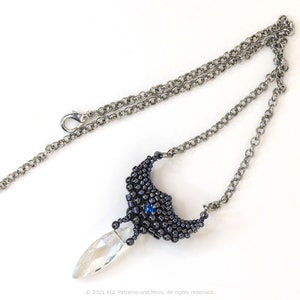 May include: A silver chain necklace with a black and blue beaded pendant featuring a clear crystal drop.