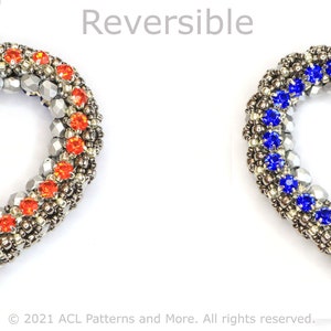 May include: Reversible heart-shaped pendant with a silver chain. One side features orange crystals and the other side features blue crystals.