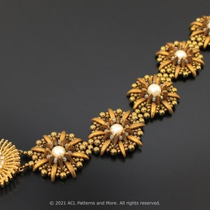 May include: A gold beaded bracelet featuring a series of star-shaped charms, each with a white pearl at its centre. The bracelet is crafted from small gold beads and has a clasp fastening.