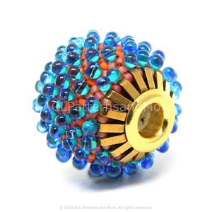 May include: A round bead with a gold metal base and a colourful design. The bead is covered in small blue, green, and orange beads. The bead has a hole in the centre for threading.