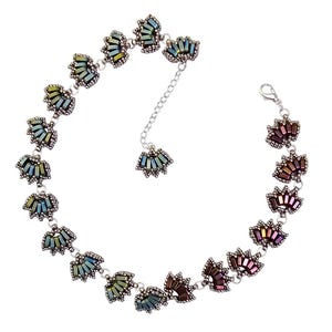 May include: A silver necklace with a delicate chain and a series of iridescent blue, green, and brown fan-shaped bead clusters.