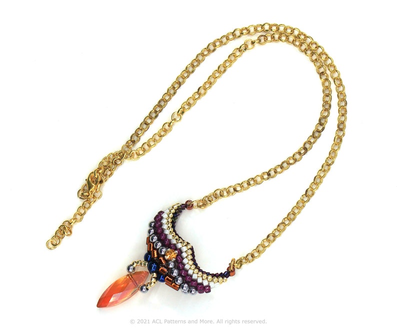 May include: A gold chain necklace with a beaded pendant featuring a teardrop-shaped orange gemstone and a multi-colored beaded design.