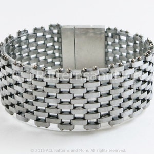 May include: A silver metal bracelet with a woven design and a magnetic clasp.