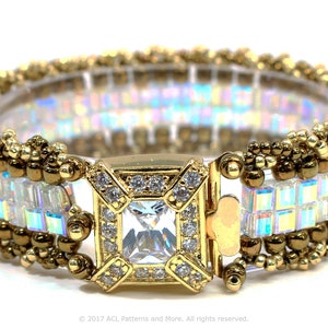 May include: A gold beaded bracelet with a clear iridescent crystal centre and a gold clasp. The bracelet is made with small gold beads and clear iridescent square crystals.
