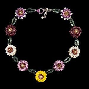 May include: A beaded necklace with a silver clasp and multiple flower-shaped charms in shades of pink, purple, white, yellow, and brown.
