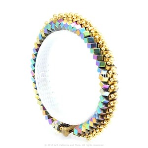 May include: A multi-colored iridescent bracelet with gold accents. The bracelet is made of small square beads and is designed in a zig-zag pattern.