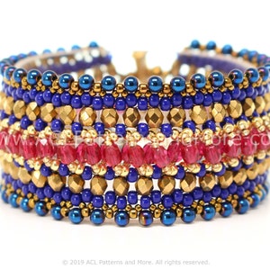 May include: A wide beaded bracelet in shades of blue, gold, and fuchsia. The bracelet features rows of small blue and gold beads, with a central band of faceted fuchsia beads. The bracelet is a cuff style.