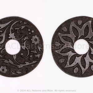 May include: Two round, dark brown wooden embellishments with intricate floral designs carved into the surface. The designs are in a lighter shade of brown. Each embellishment has a hole in the centre.