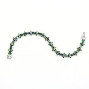 May include: A green and silver beaded bracelet with a clasp fastening.