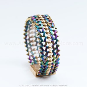 May include: A multi-coloured iridescent beaded bracelet with gold beads. The bracelet is woven in a chevron pattern.