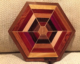 Hexagon shaped wood wall art sculpture featuring a variety of exotic wood pieces geometrically arrayed.