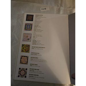 May include: An open book page with a list of boutiques in various cities. The page features colorful square illustrations and text, including city names like Tokyo, Kyoto, and Hong Kong. The number 7216 is in the top corner.