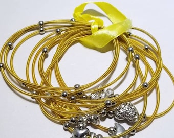 Bee Charming gold piano wire bracelets with charms