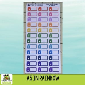May include: A sheet of rectangular stickers featuring protein tracker icons in a rainbow color gradient. Each sticker displays a bottle graphic with a lightning bolt and the text PROTEIN. The top of the sheet reads SPRING TOAD DESIGNS.