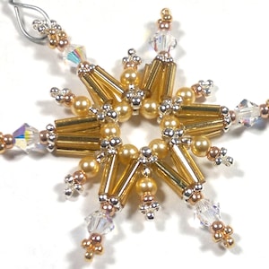 May include: A gold and clear beaded snowflake ornament. The snowflake is made with gold and clear beads, and has a silver wire loop for hanging.