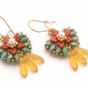 May include: A pair of gold earrings with a red, green, and yellow beaded flower design.