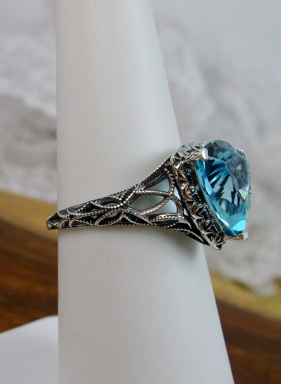 Blue Topaz Ring Marquise Cut with Heart and Bead Design Sterling Silver Blue Topaz Ring Marquise Cut with Heart and Bead Design Sterling Silver
