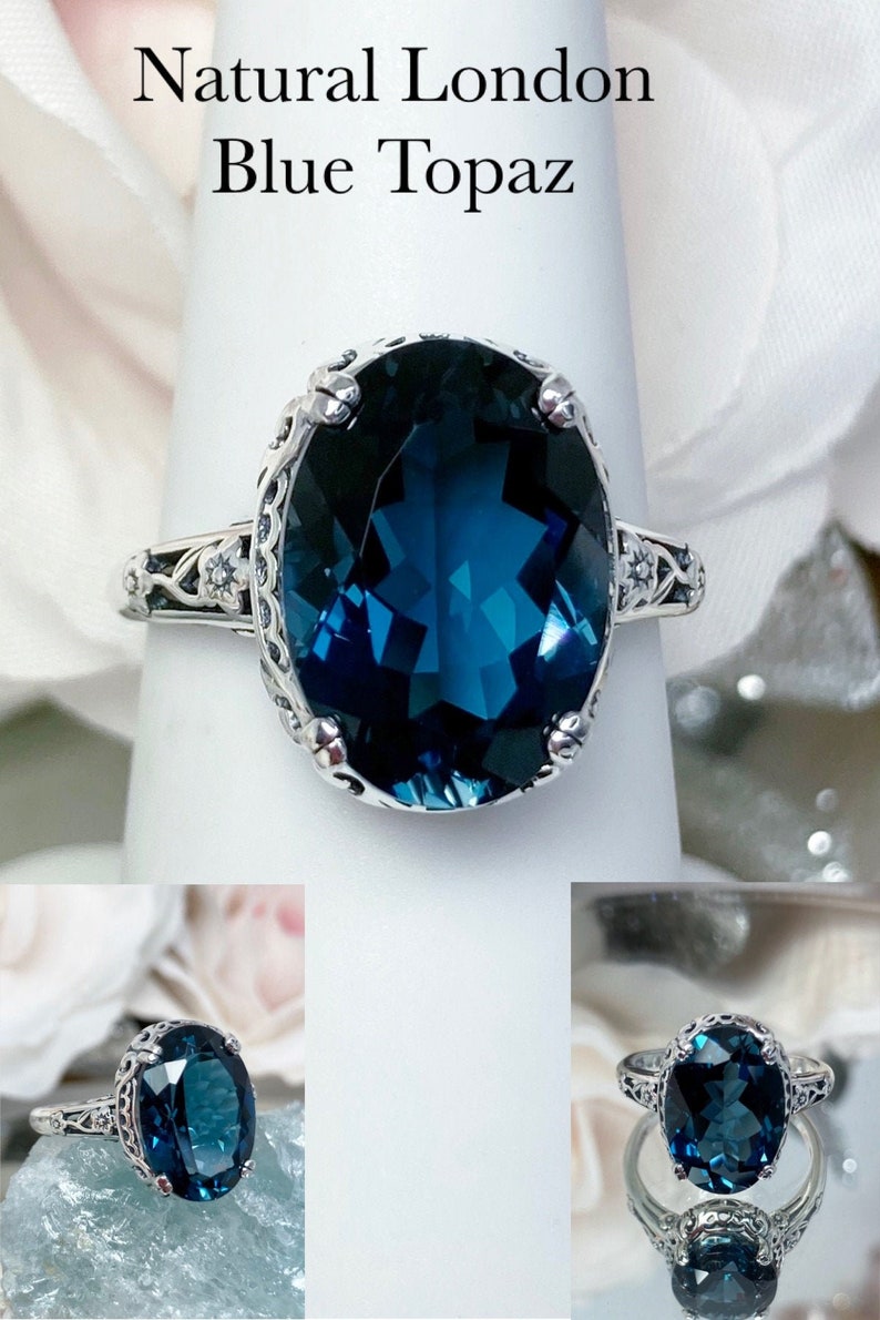 May include: A silver ring with a large, oval-shaped, blue topaz gemstone. The ring has a delicate, ornate design with small, white gemstones.