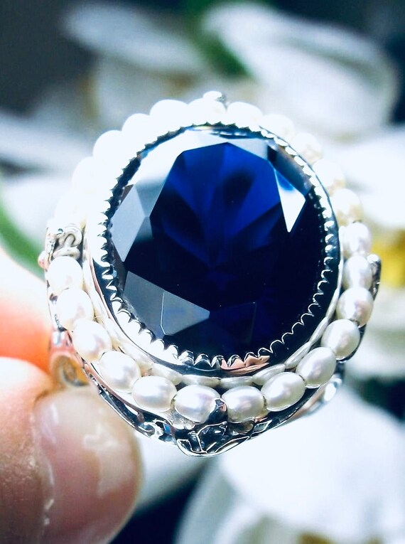 Bague avec perle bleu sale