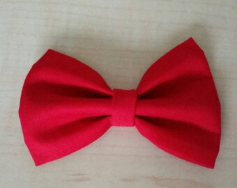 May include: A bright red fabric bow tie.