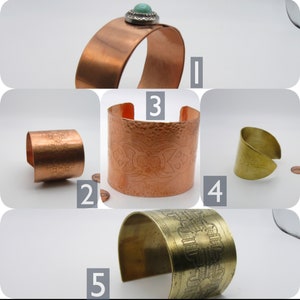 May include: Five copper and brass bracelets with different designs. Some bracelets have a hammered texture, while others have intricate patterns. One bracelet has a turquoise stone.