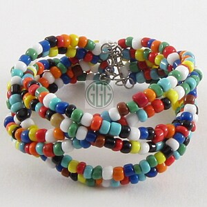 May include: Multicoloured beaded bracelet with a silver clasp. The bracelet is made of small, round beads in various colours, including red, orange, yellow, green, blue, and black.